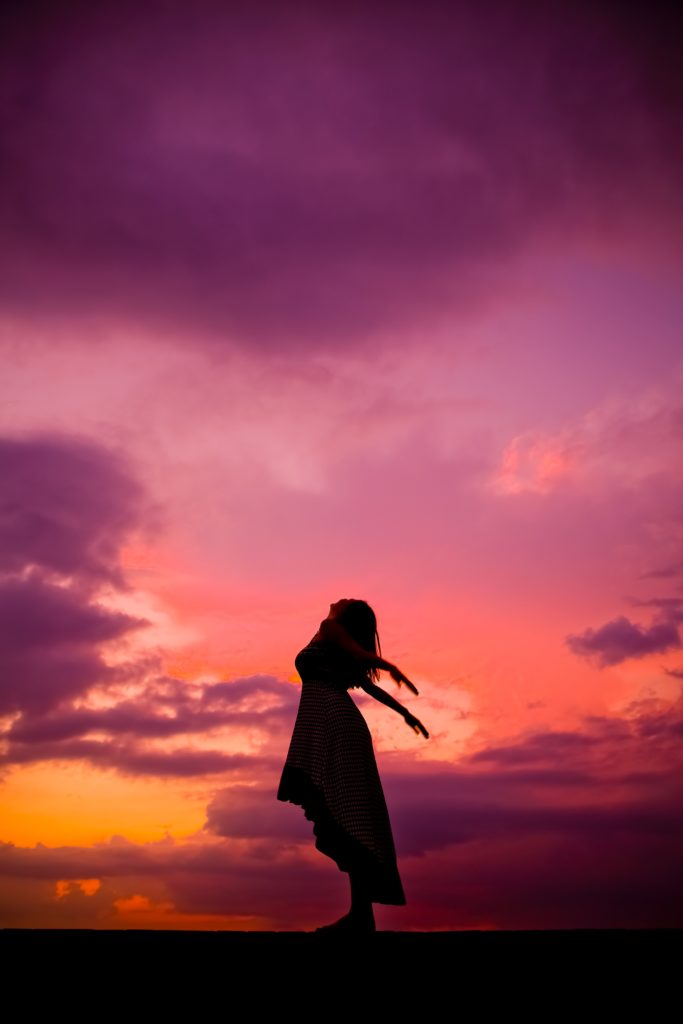 A girl facing towards sky.